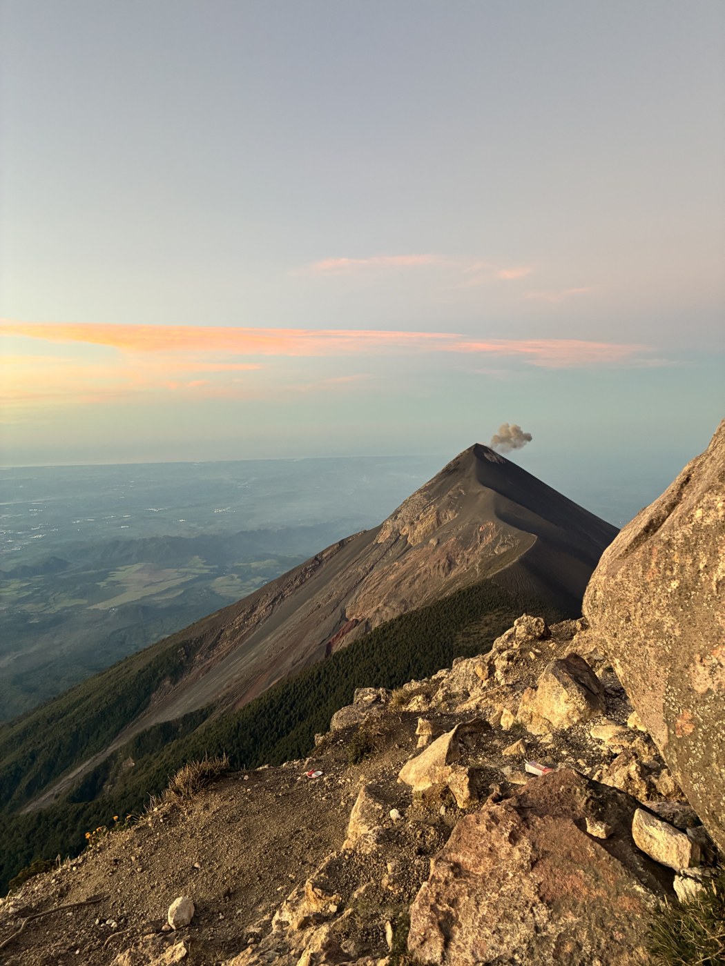 Sunrise on the Acatenango ridge in Guatemala, Volcan de Fuego erupting in the distance